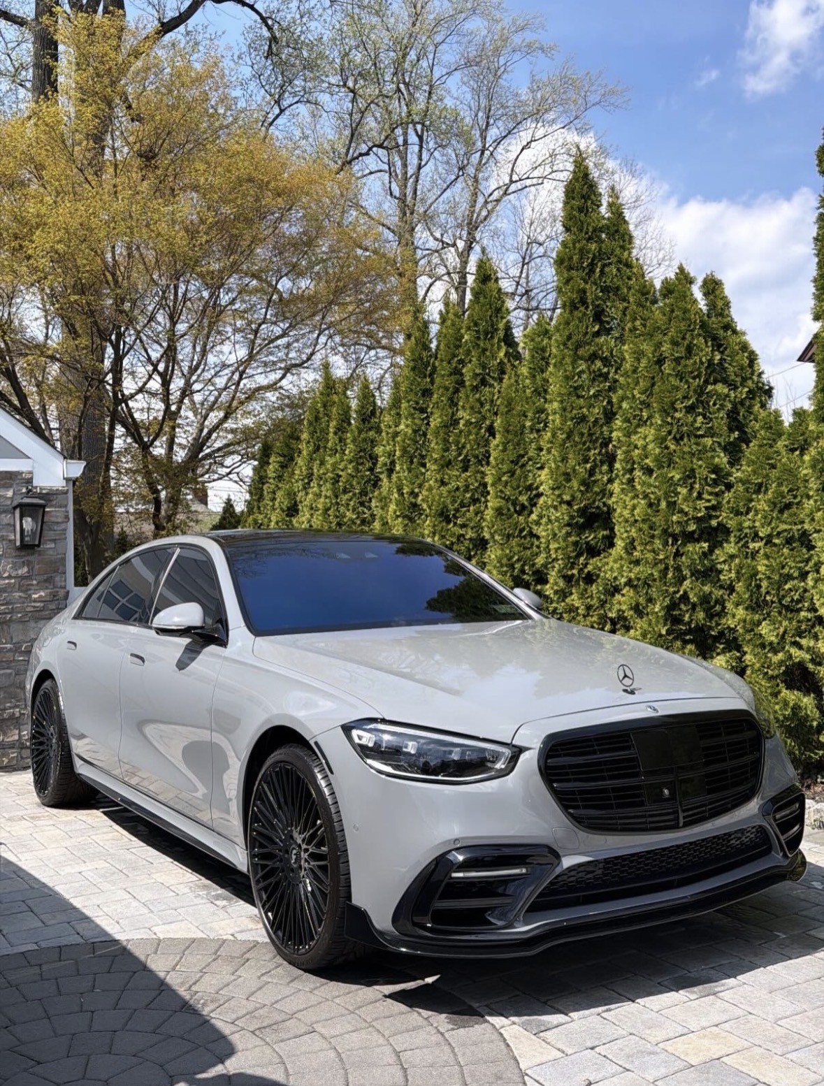 Detailer hand-polishing a luxury car hood