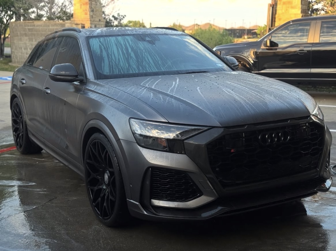 Glossy black luxury sedan with gold accents — premium mobile car detailing